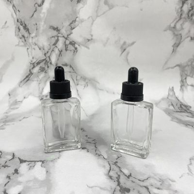 正方形30mlのガラス化粧品はヘアー ケア オイルのための点滴器のChildproof帽子をびん詰めにする