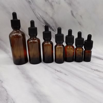 100mlこはく色のガラス化粧品は子供を保護するために点滴器のラチェットの閉鎖をびん詰めにする